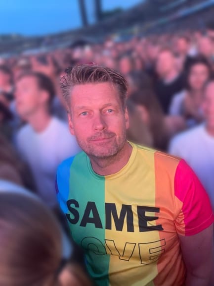 Emil Pettersen standing in a crowd at an outdoor concert wearing a rainbow-colored shirt with the text “SAME LOVE.” The photo symbolizes inclusion, equality, and Emil’s engagement in community and cultural initiatives connected to sustainability and shared values.